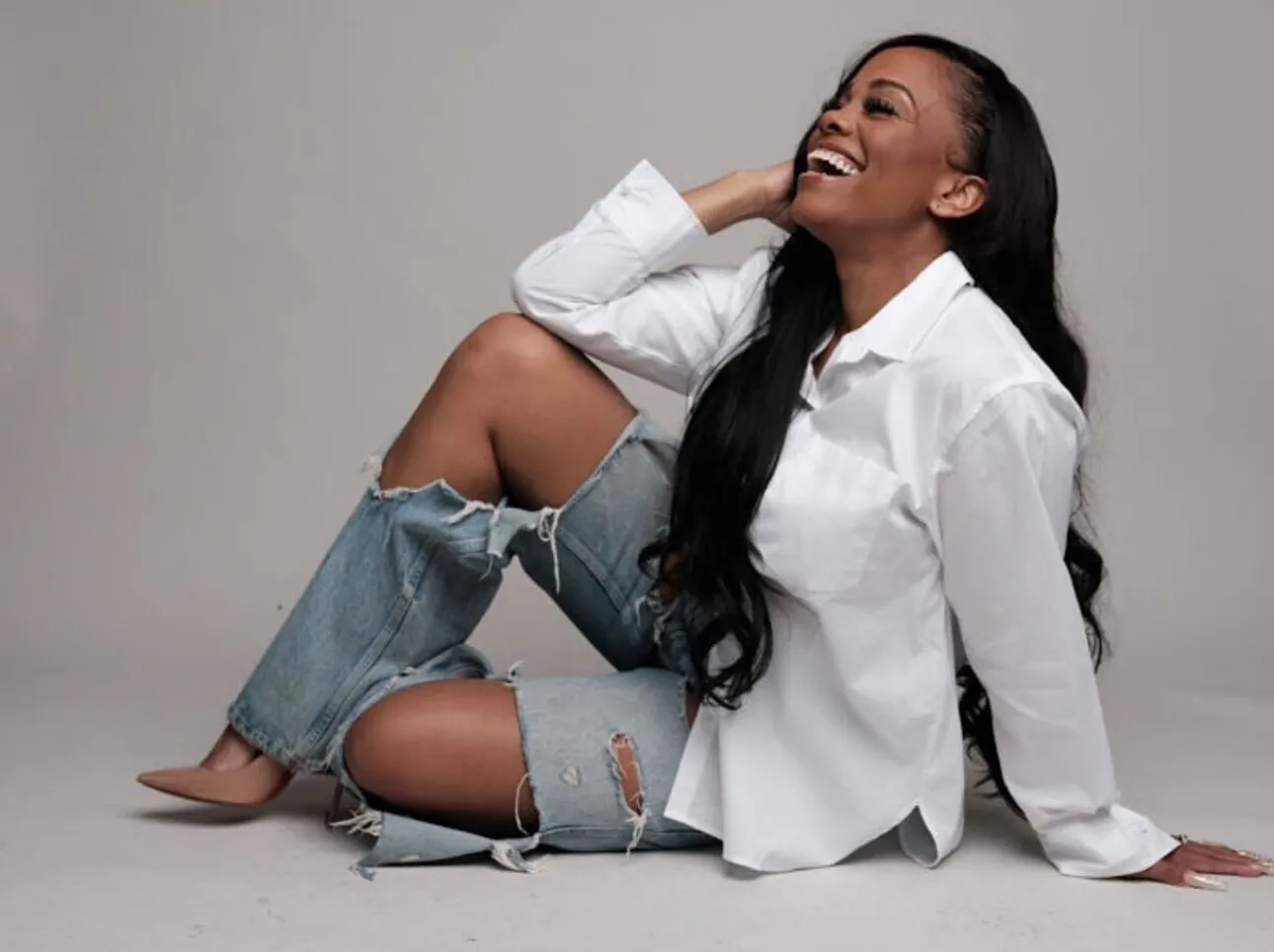 Stephanie Shabazz seated, laughing